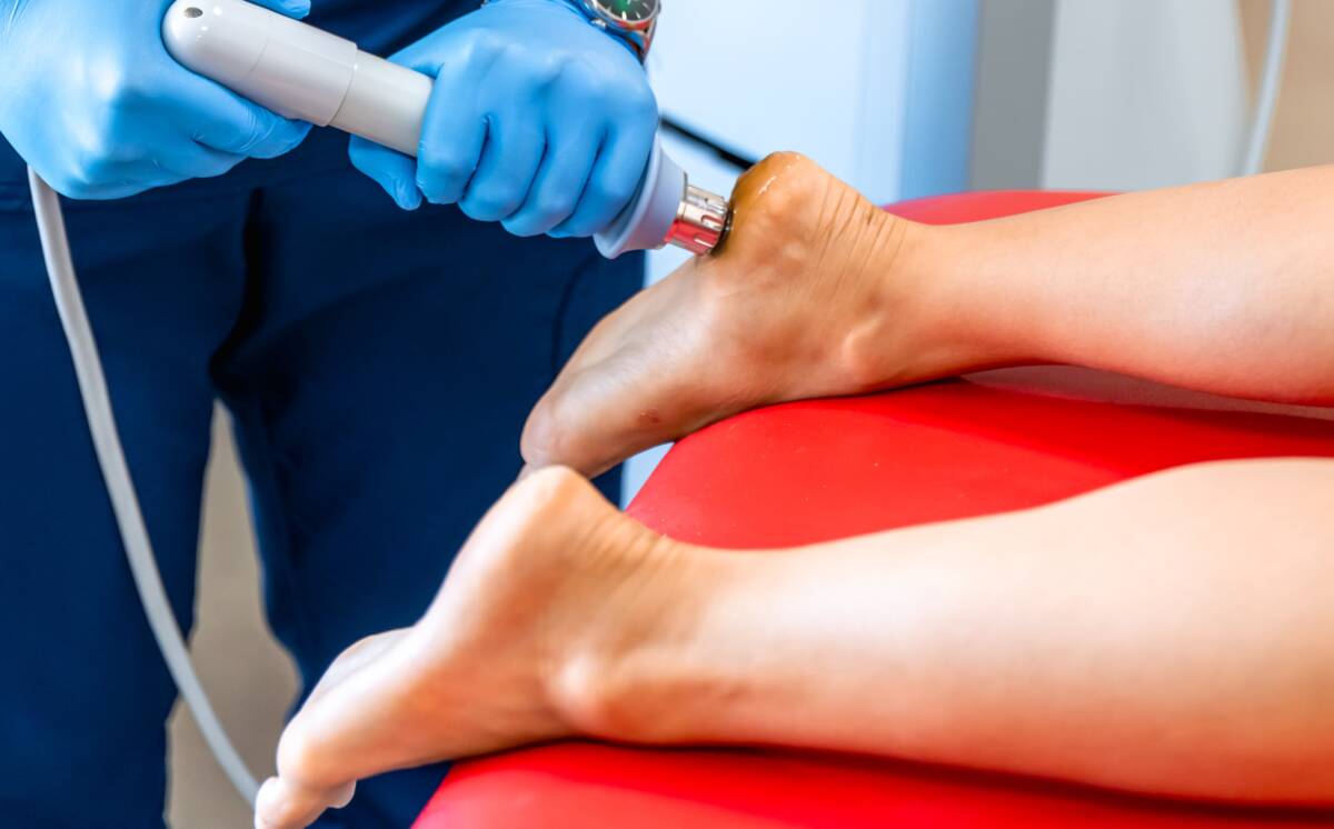 Patient getting non-surgical treatment with shock waves for plantar fasciitis.